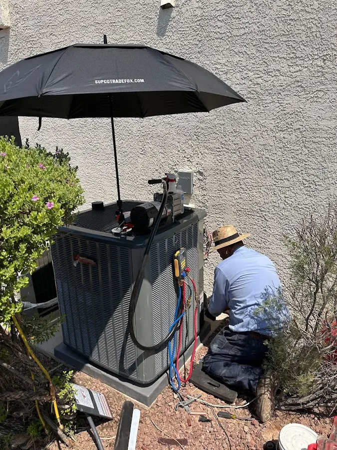 HVAC technician performing outdoor AC maintenance in Somers Point